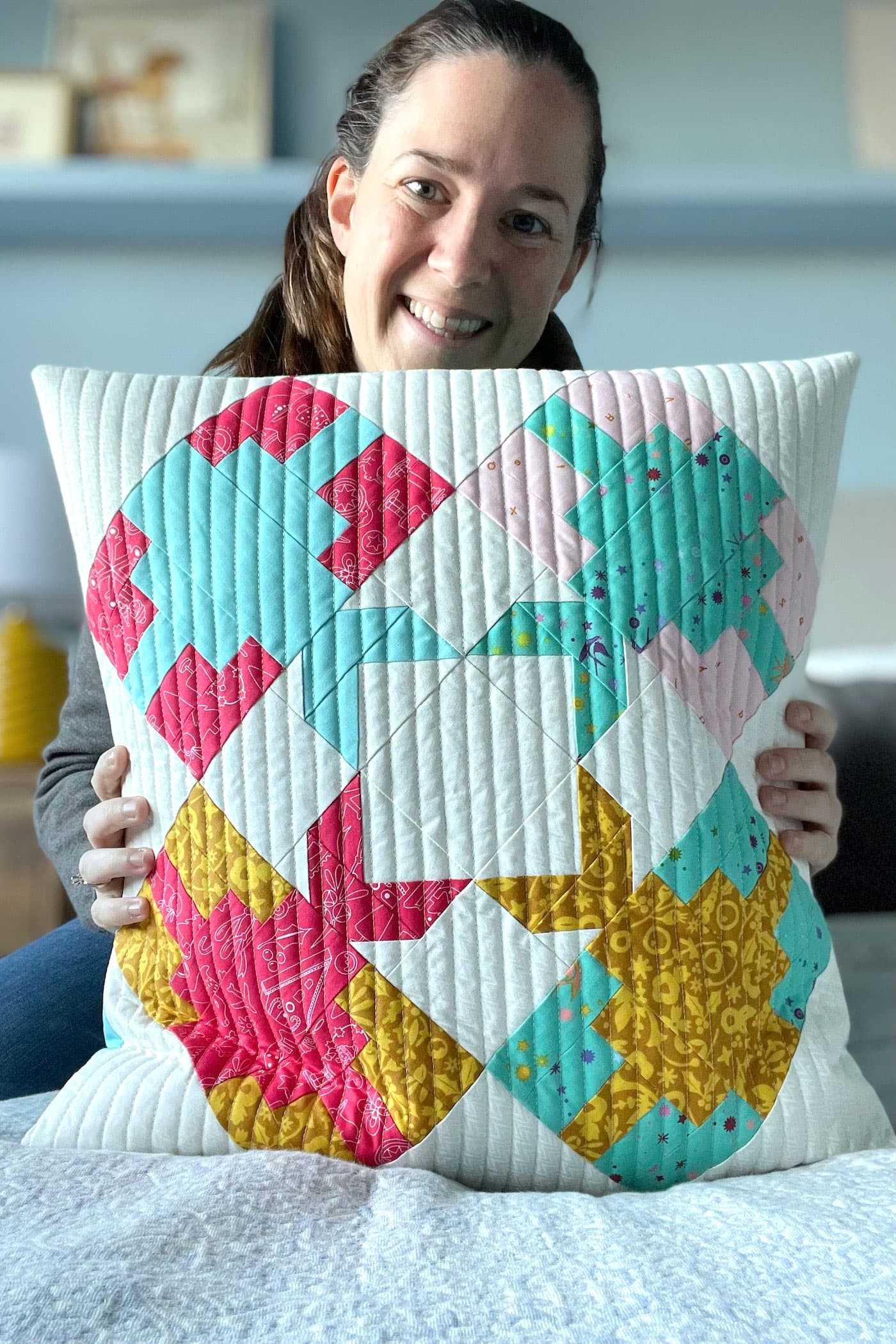 Woman holding patchwork pillow