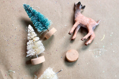 small toy trees and deer on table