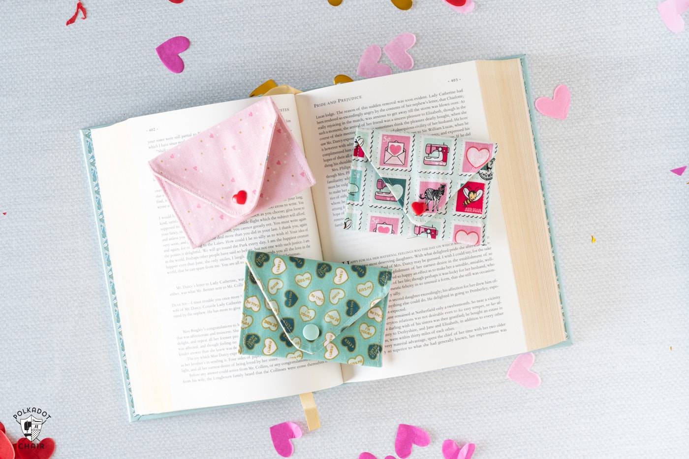 colorful fabric envelopes on white tabletop with books