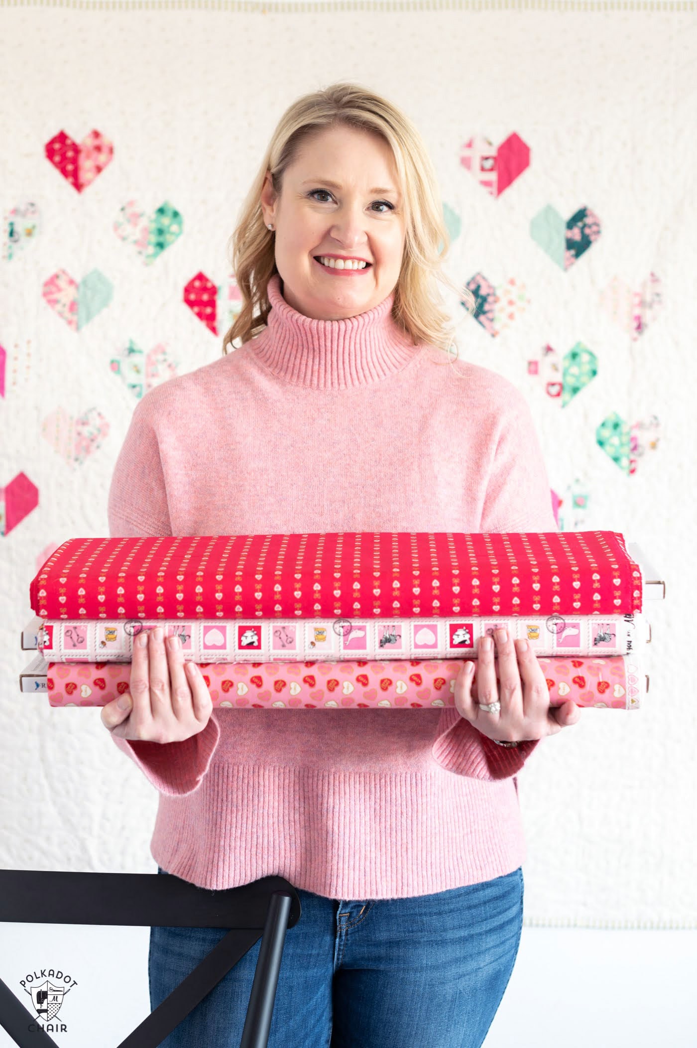 woman holding stack of valentines fabric