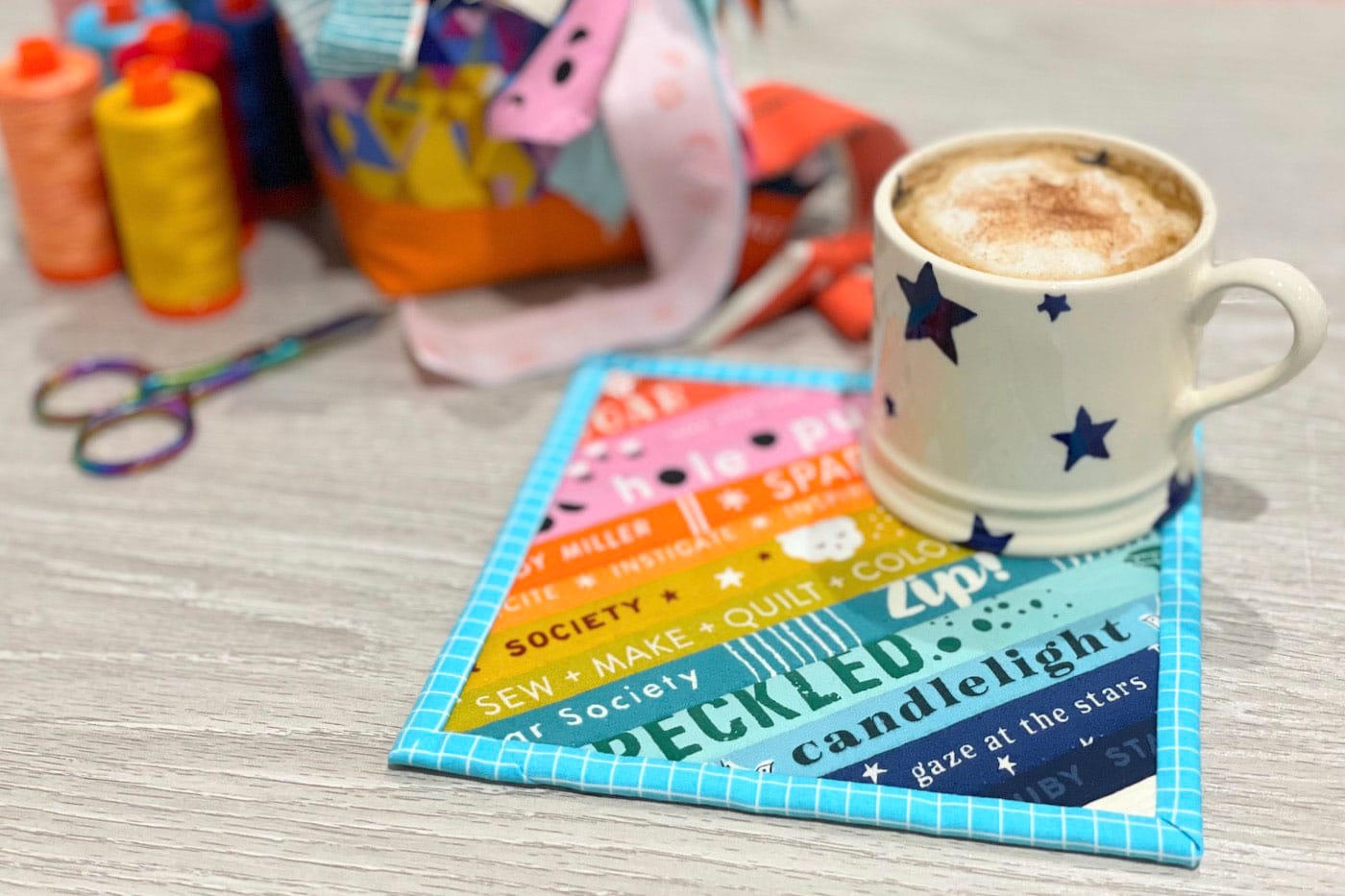 colorful mug rug on wood table with mug