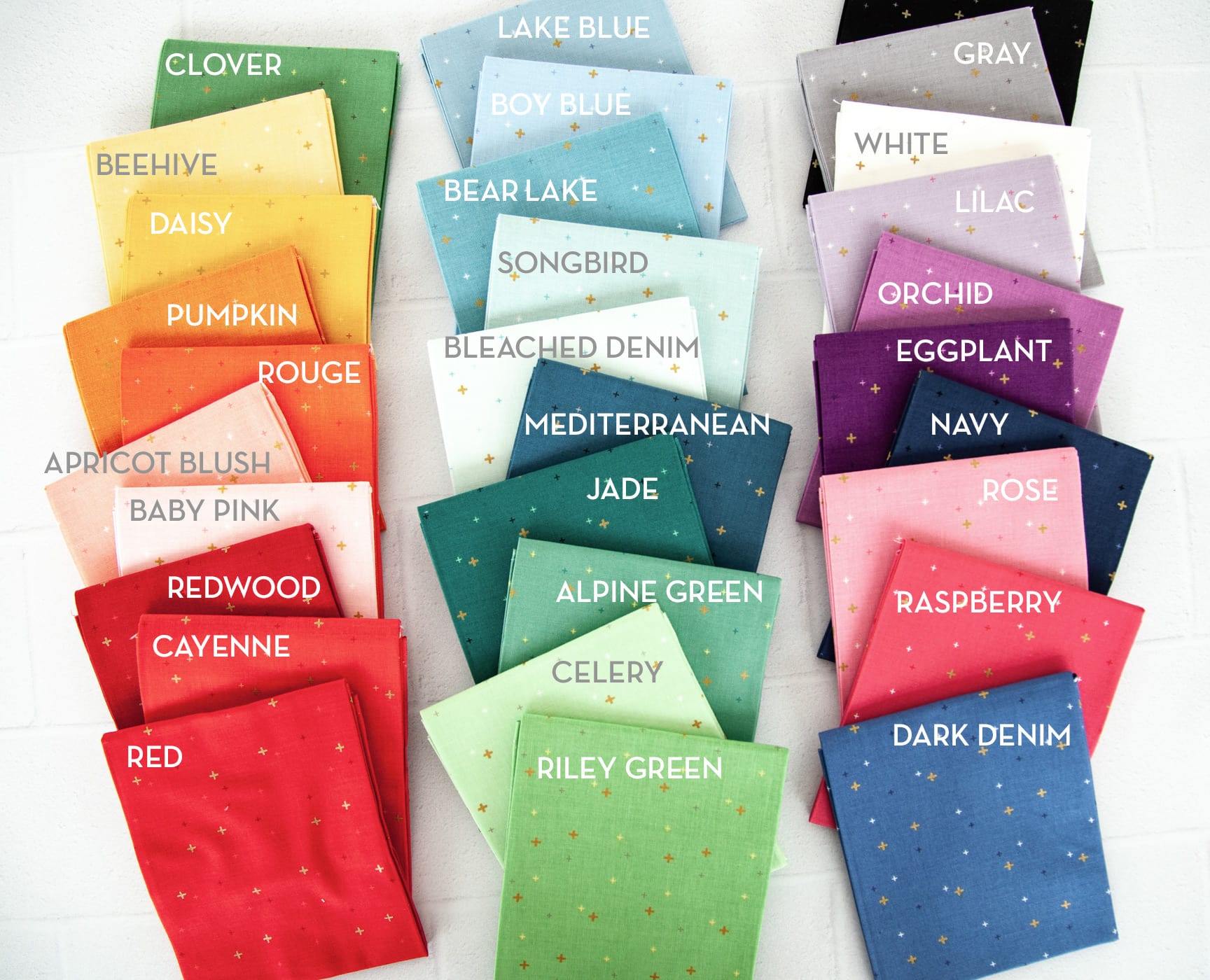 fabric swatches with color labels on white cutting mat