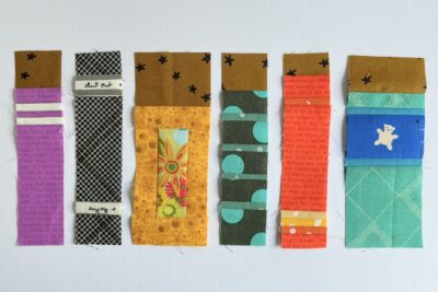 various book quilt blocks on white table in construction