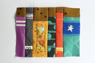 various book quilt blocks on white table in construction