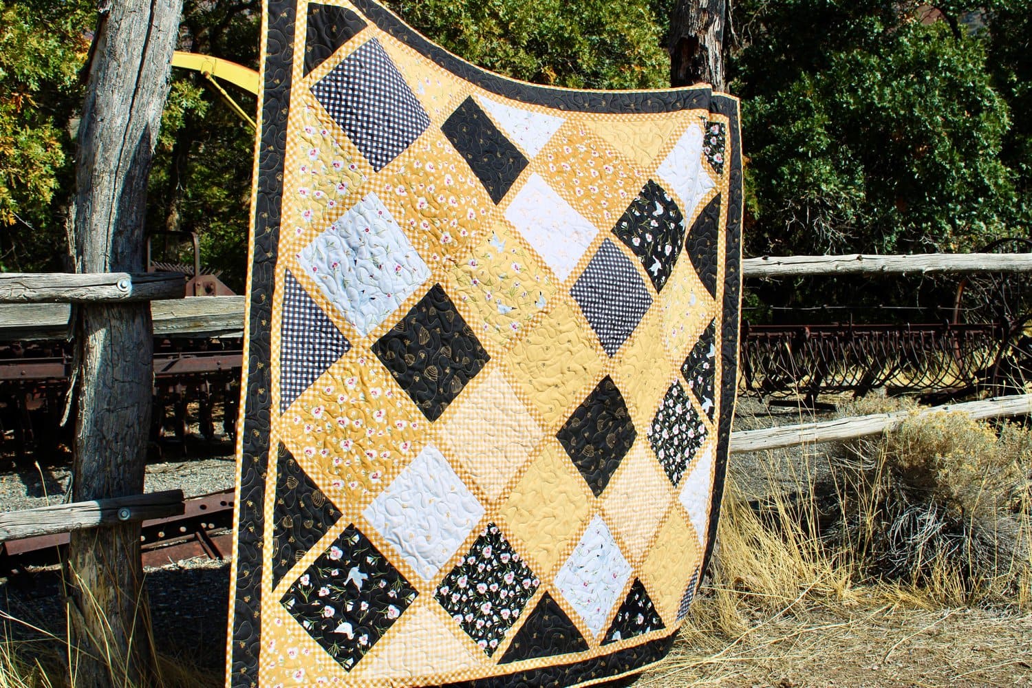 black and yellow patchwork quilt outdoors