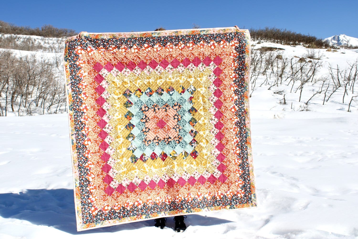 colorful patchwork quilt pattern outdoors in snow
