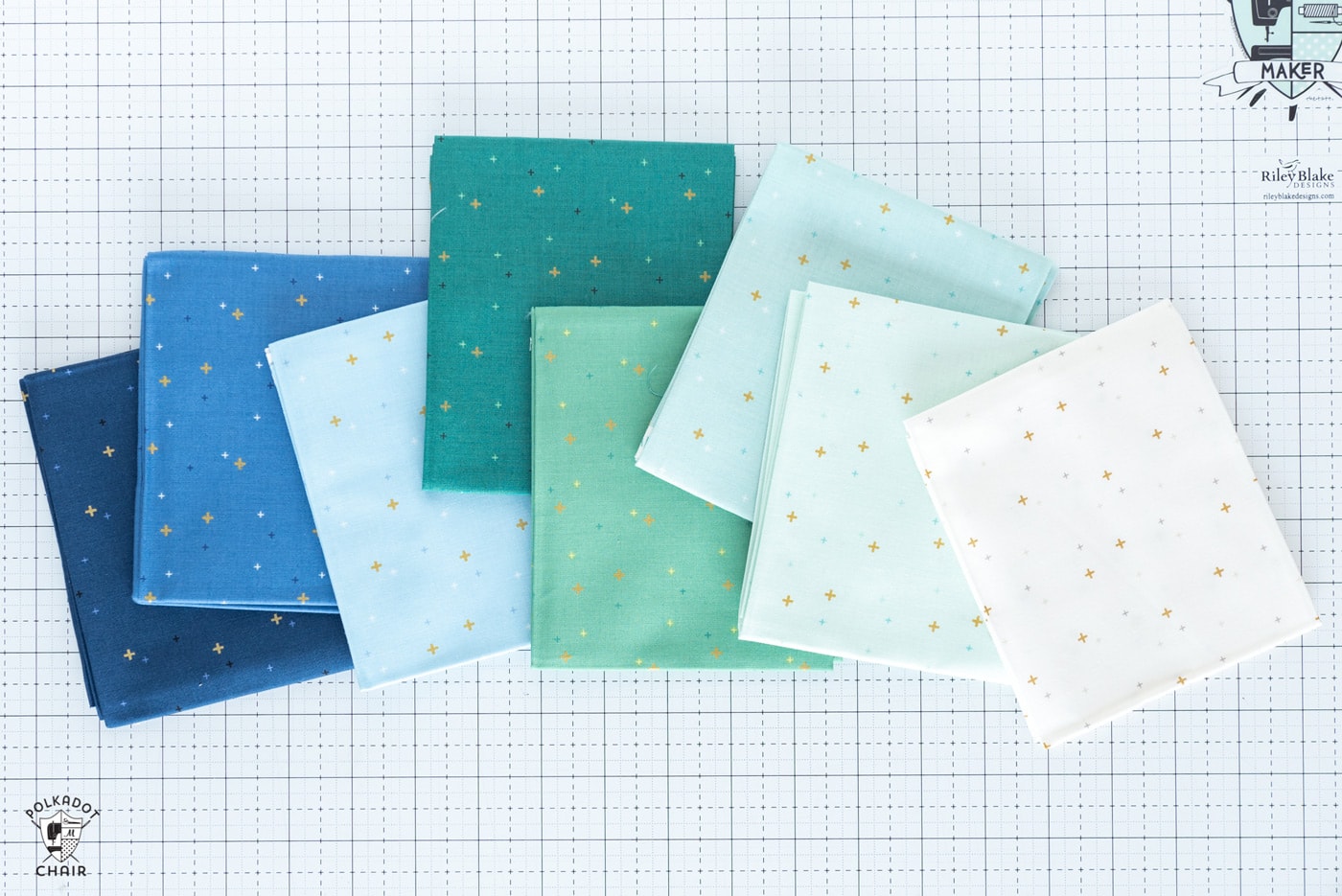 stack of colorful folded fabrics on white cutting mat