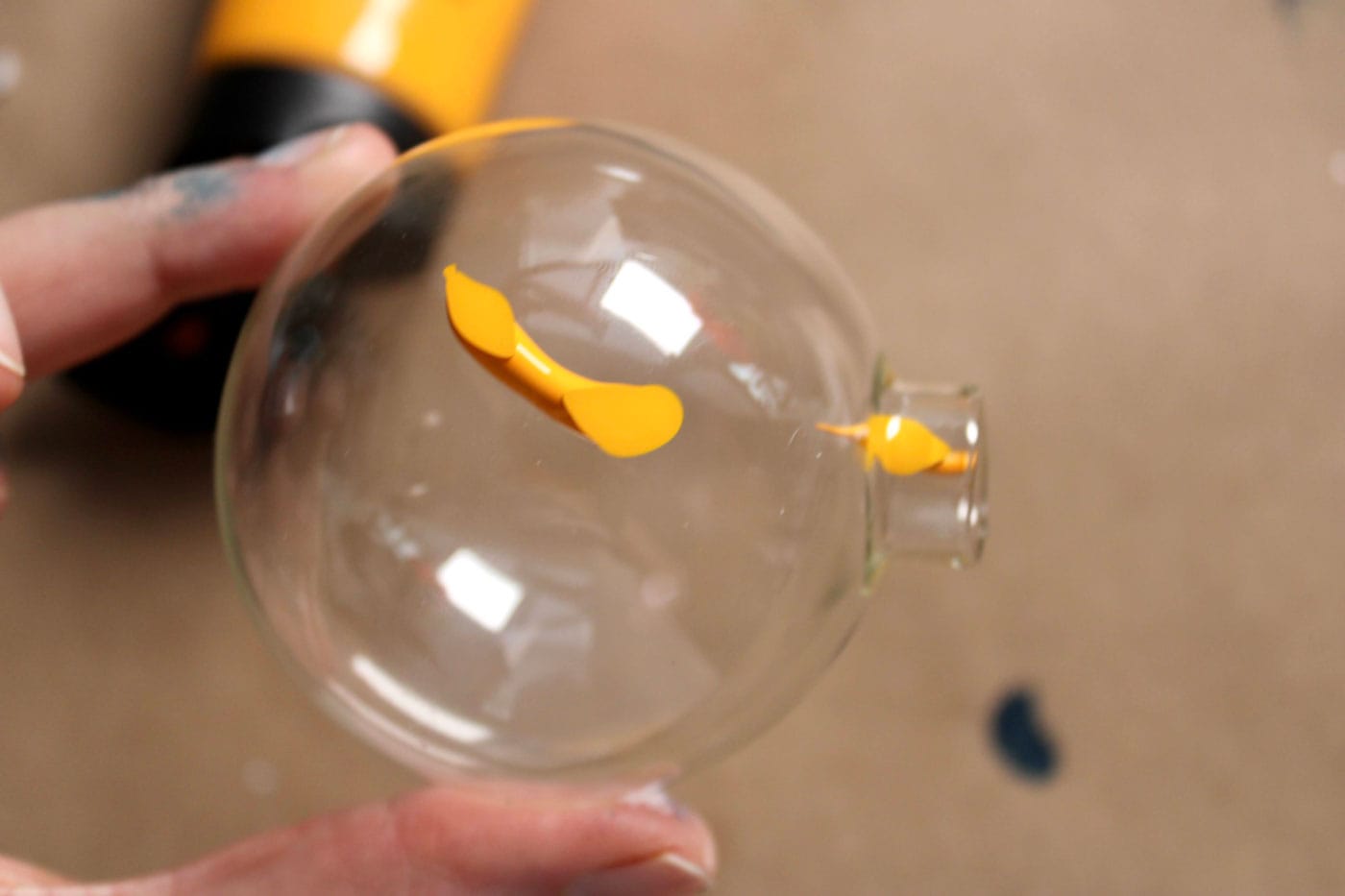 yellow paint inside of glass ornament