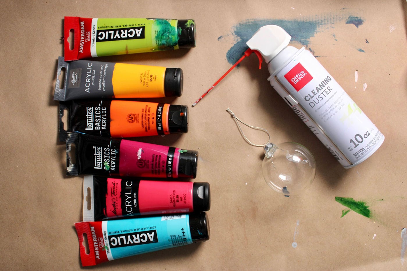 various tubes of acrylic paint on paper