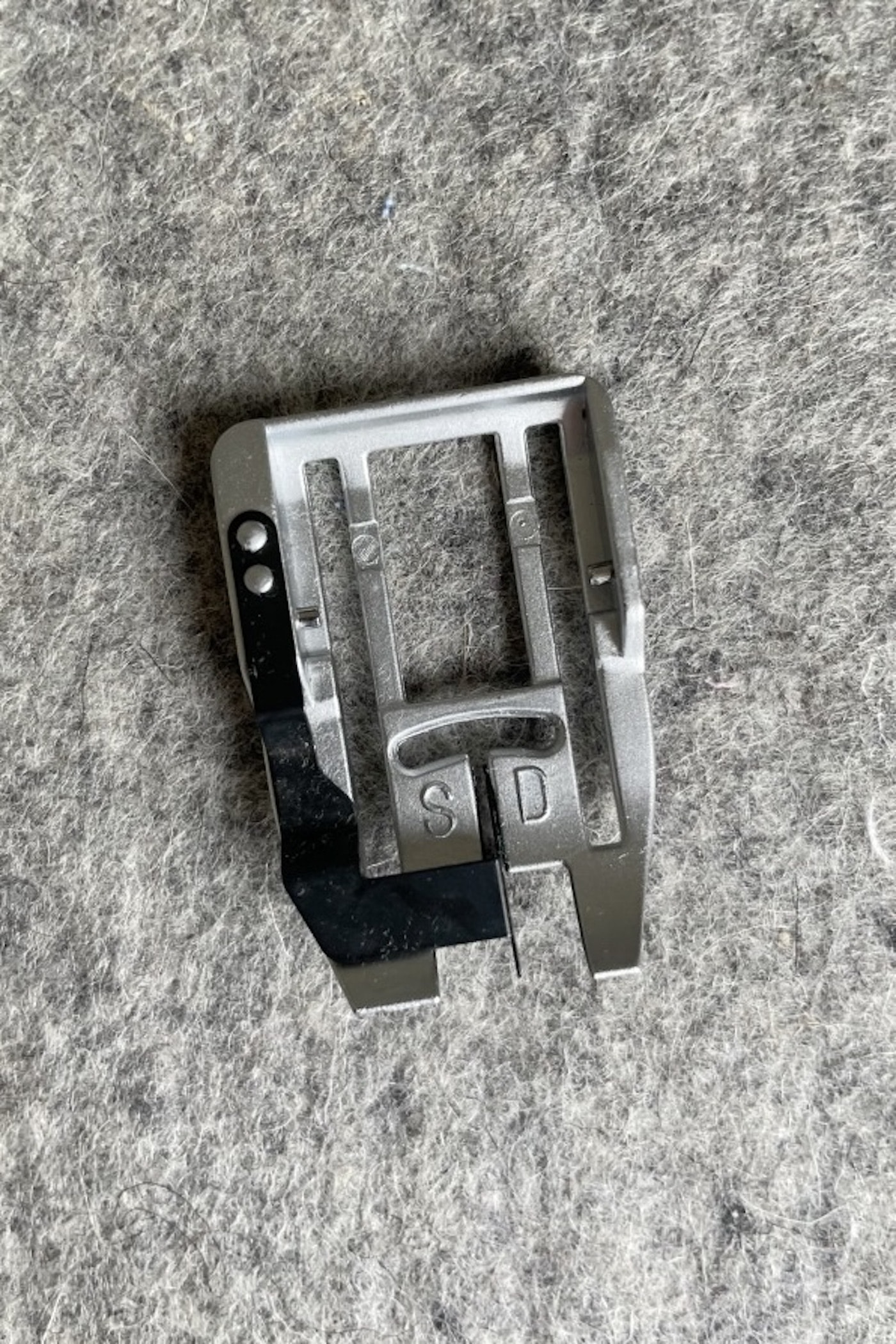close up of sewing machine foot plate