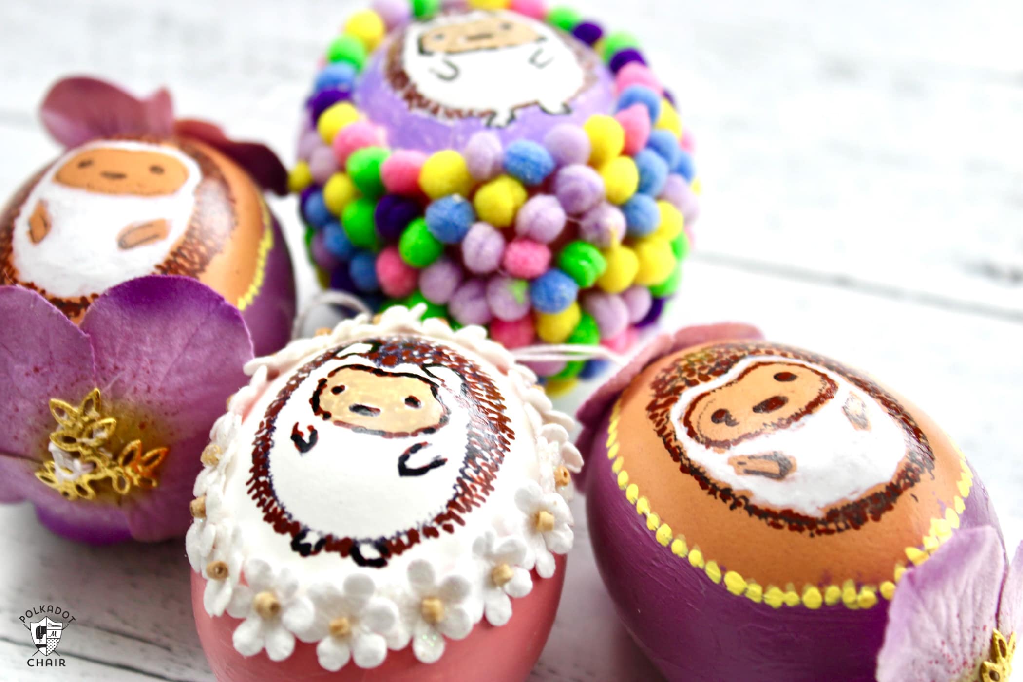 multiple blown egg ornaments with painted hedgehogs on white wood table