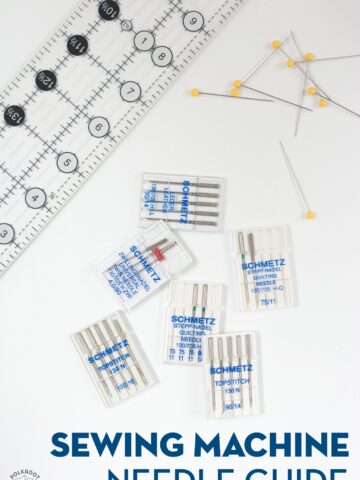 sewing machine needles on white table with ruler