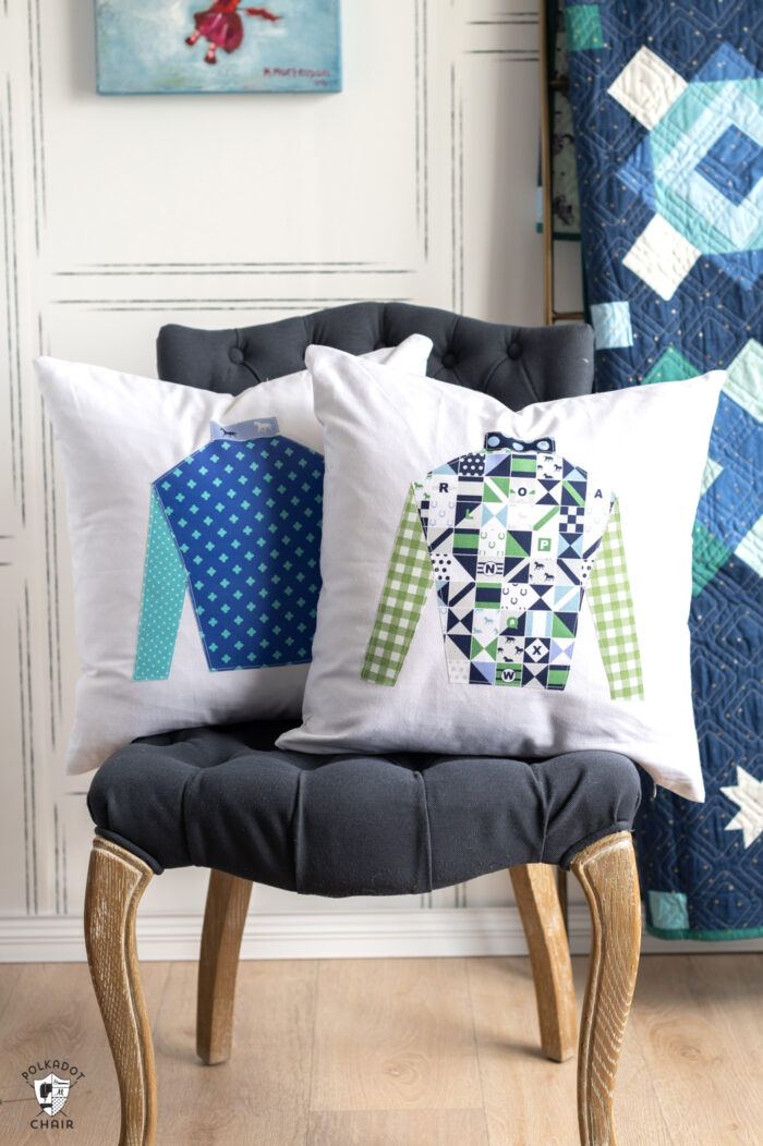 two brightly colored pillows with jockey silk applique on gray chair