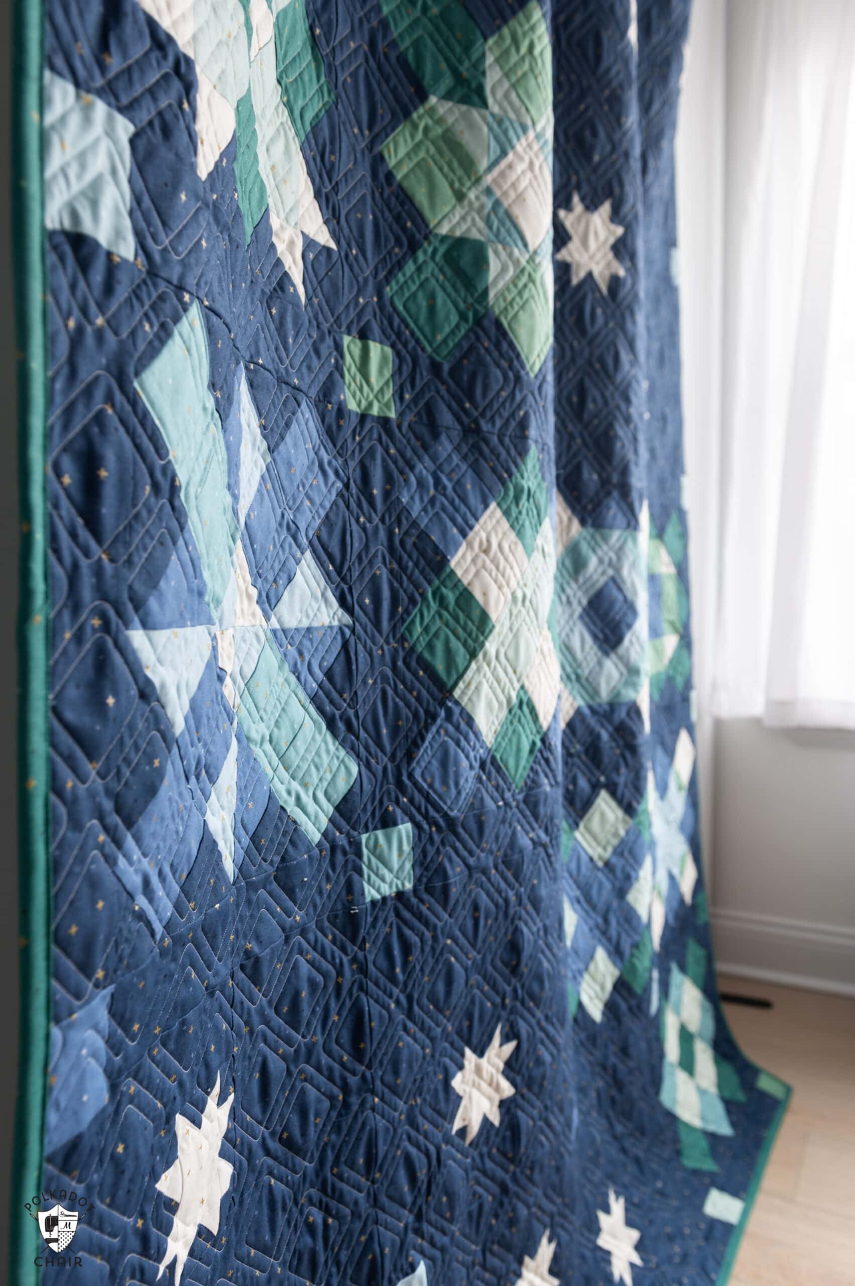 side view of navy, blue and green quilt made from squares and rectangles - a modern granny square quilt pattern