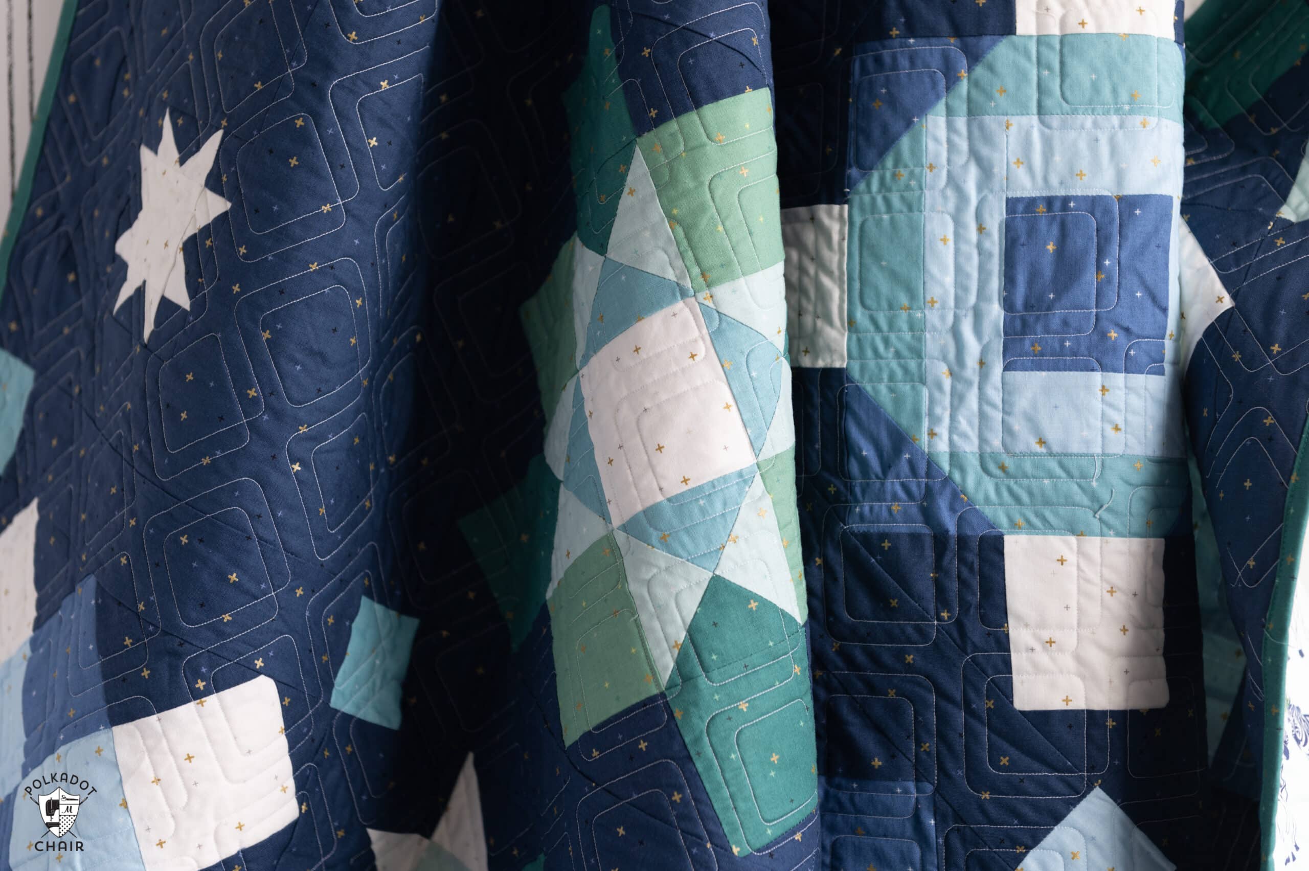 navy, blue and green quilt made from squares and rectangles - a modern granny square quilt pattern