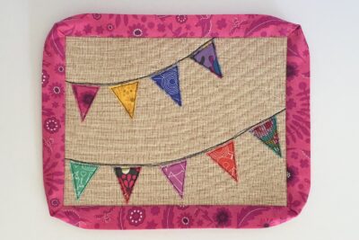 pink binding around mug rug