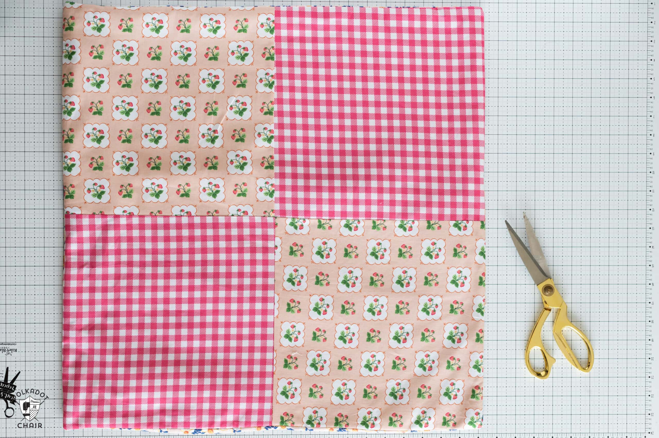 pink patchwork pillow on white cutting mat with scissors