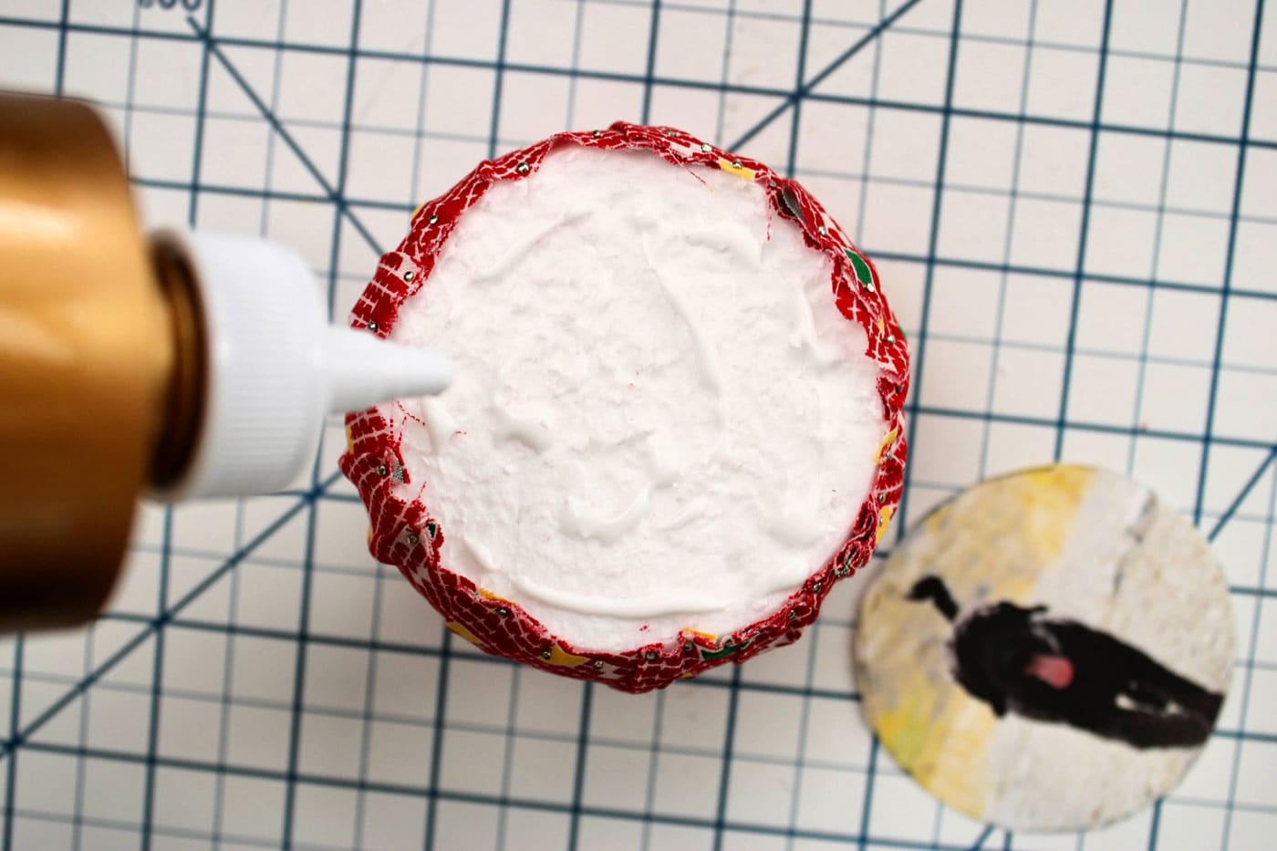 applying glue to the surface of a styrofoam ball