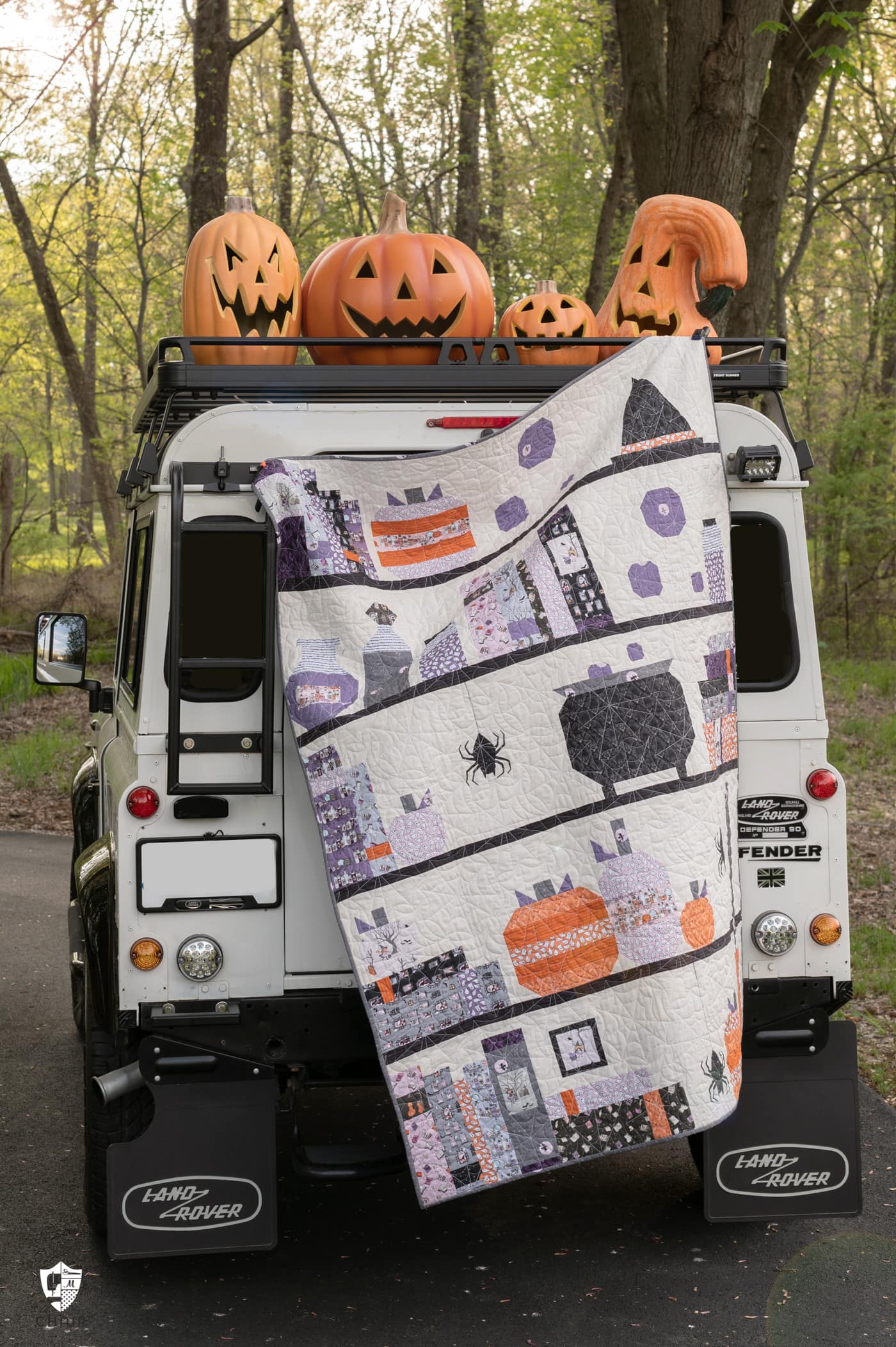Halloween quilt and vintage Land Rover with pumpkins outdoors