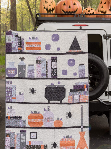 Halloween quilt and vintage Land Rover with pumpkins outdoors