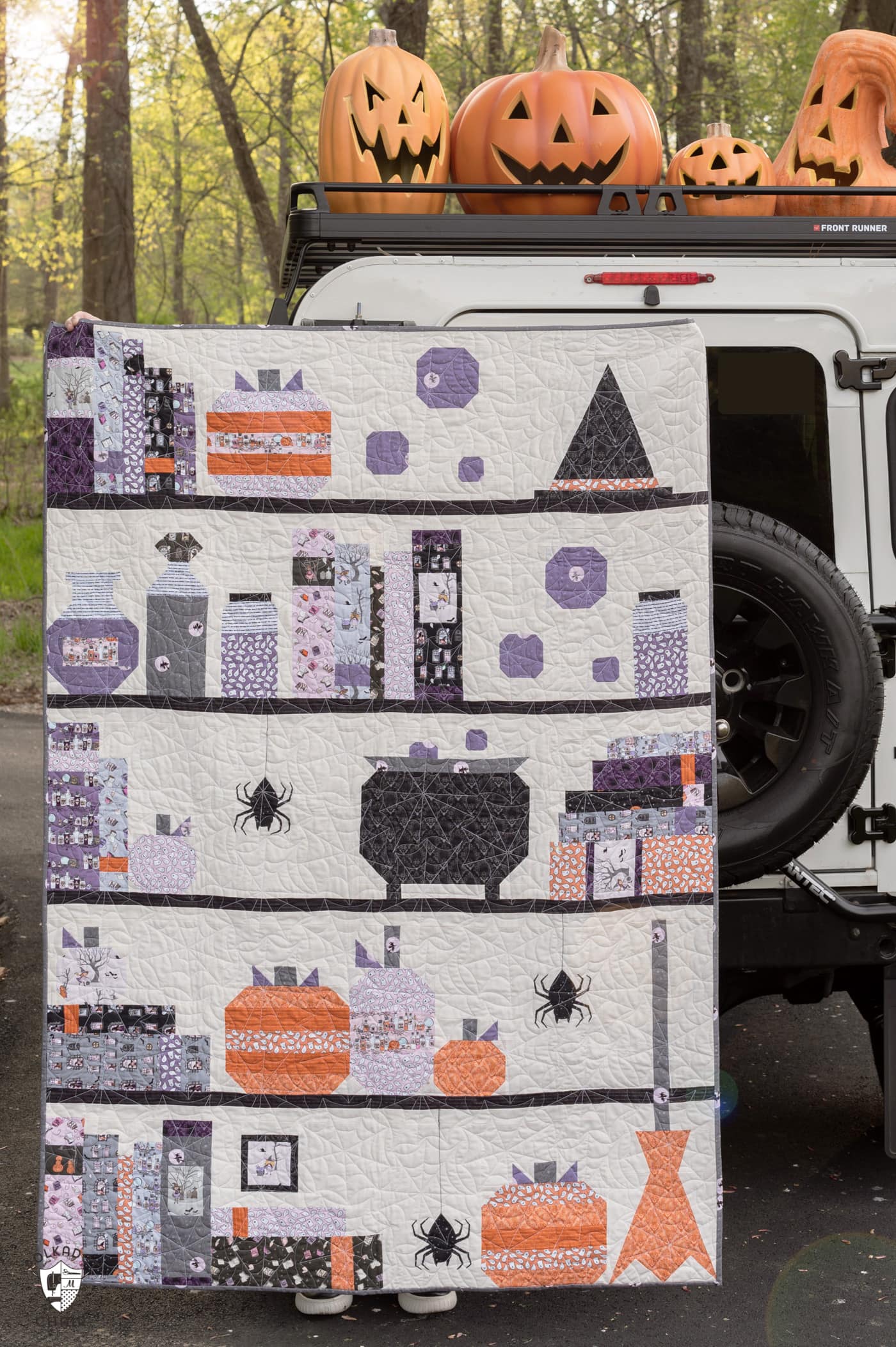 Halloween quilt and vintage Land Rover with pumpkins outdoors