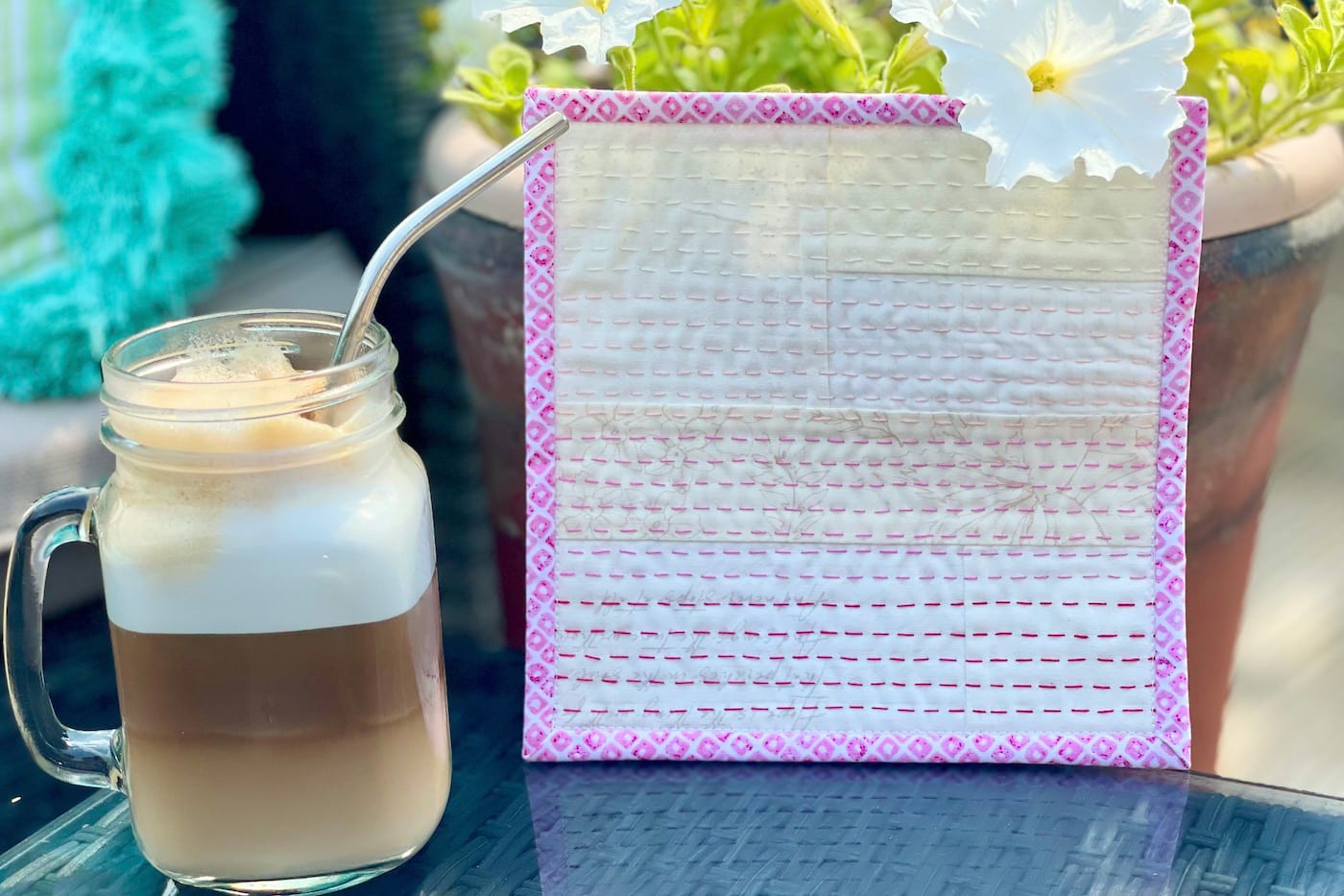 iced coffee in front of cream and pink mug rug