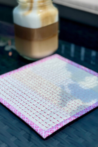 iced coffee on cream and pink mug rug