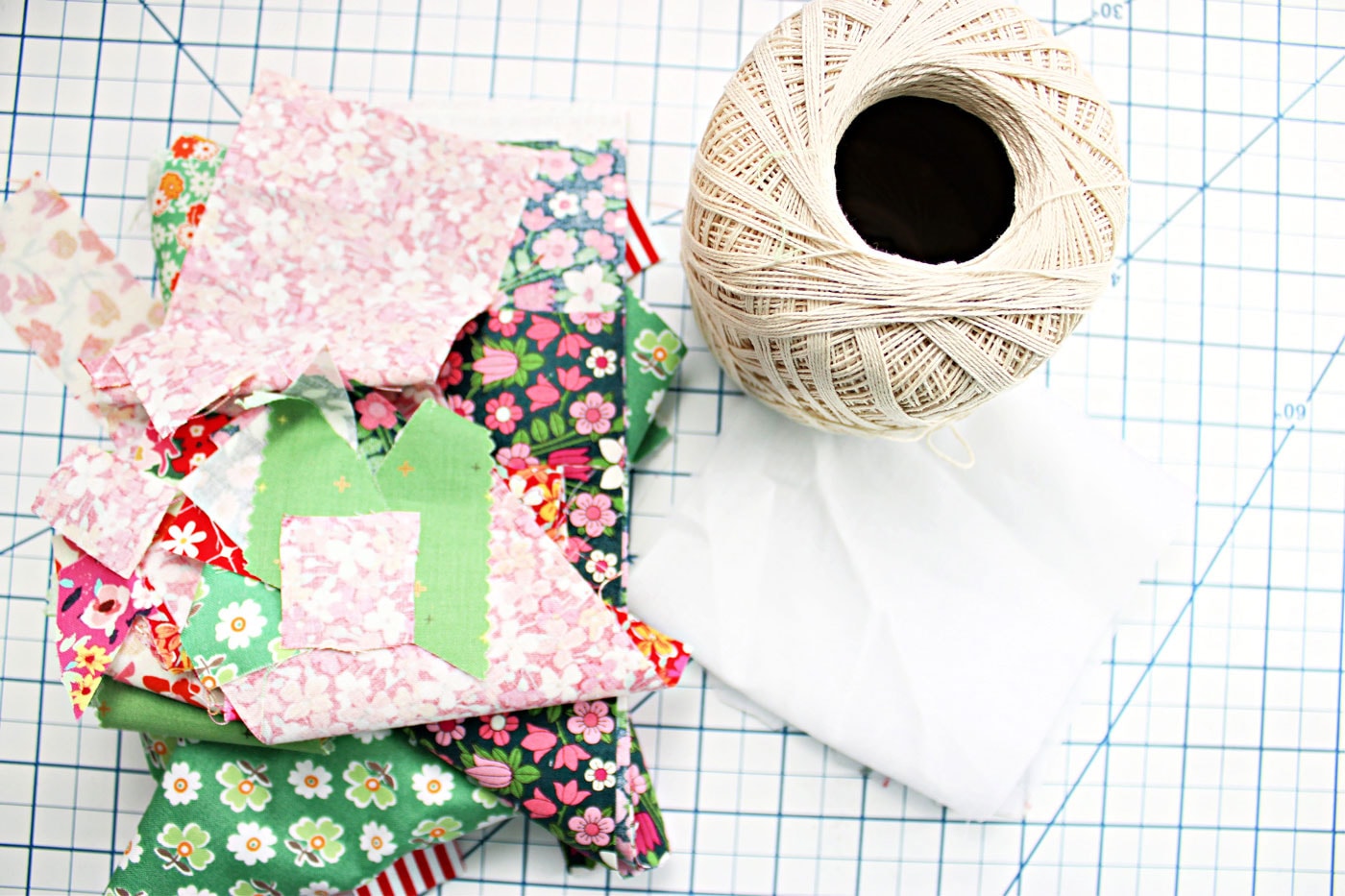 ball of string and colorful fabric scraps on table