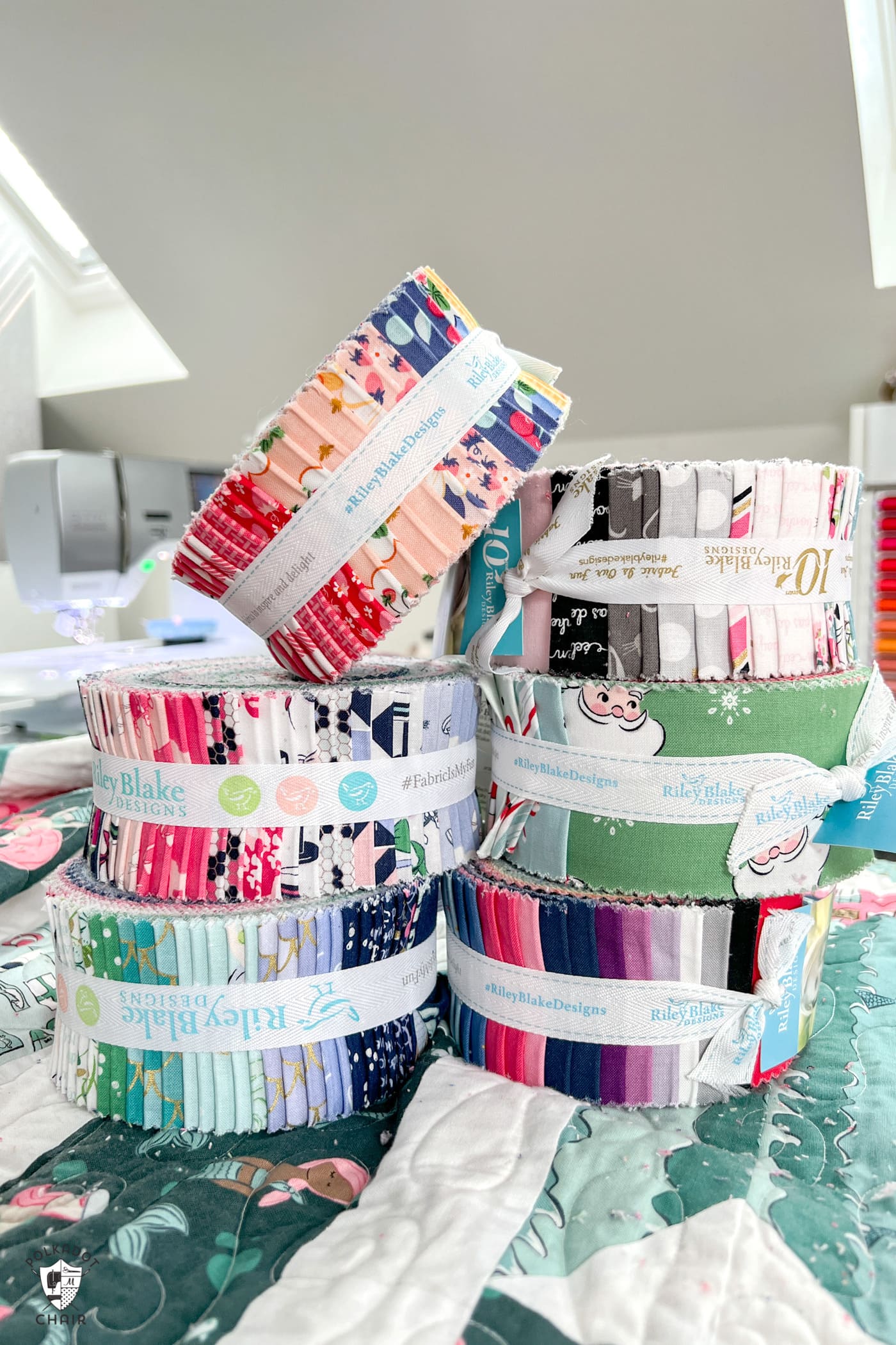 stack of precut rolls of fabric in sewing room