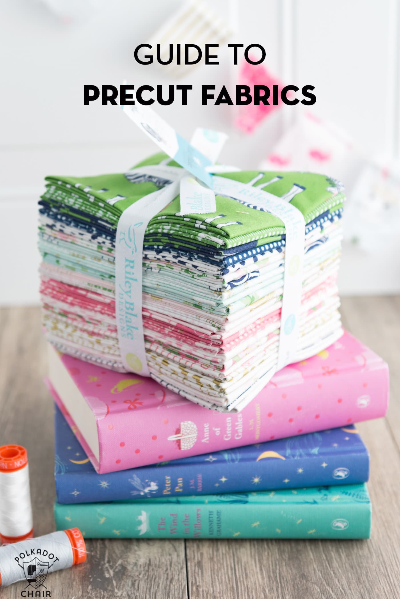 stack of precut fabrics on books