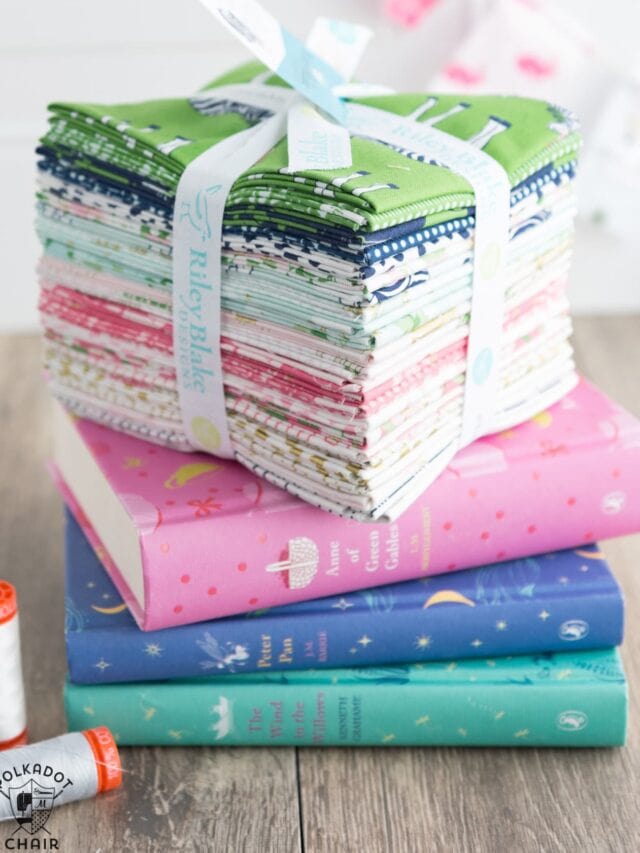 stack of precut fabrics on books