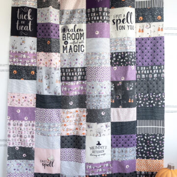quilt made from purple, black and pink rectangles & squares.