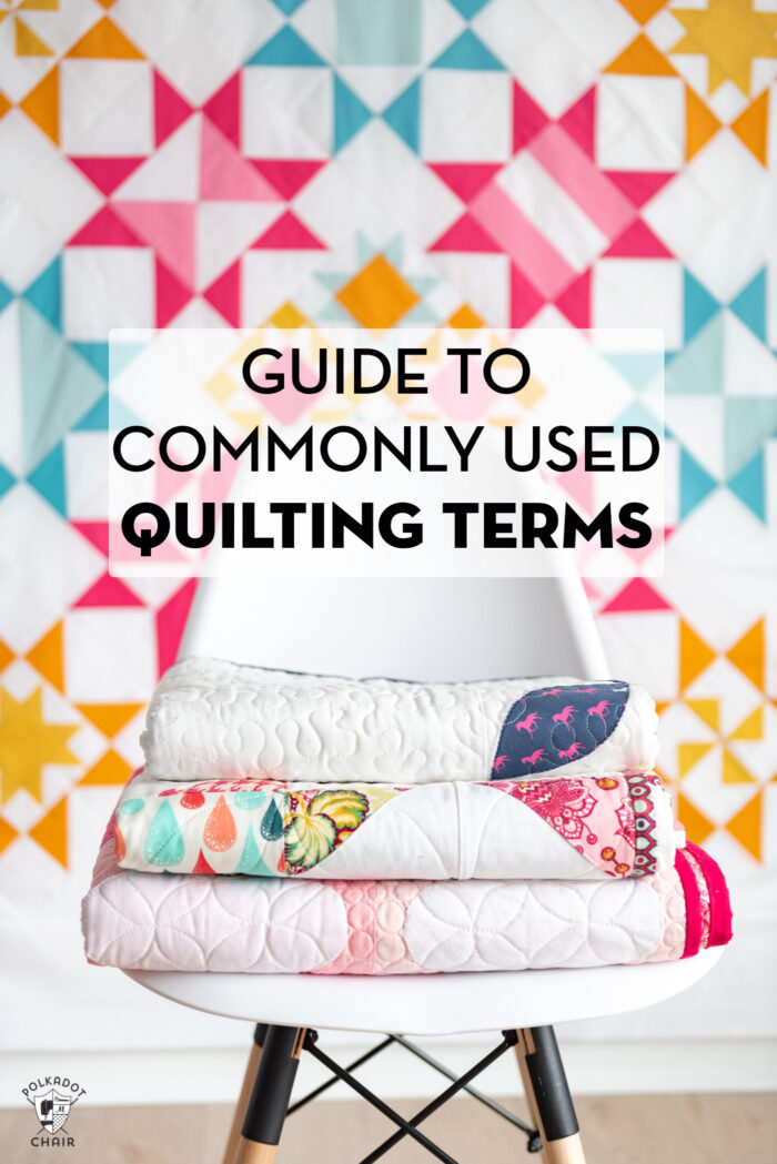 white chair with quilts stacked ontop in front of a colorful geometric quilt with text overlay