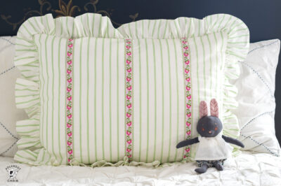 green and white striped pillow on bed