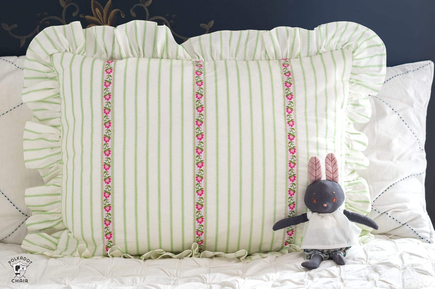 green and white striped pillow on the bed