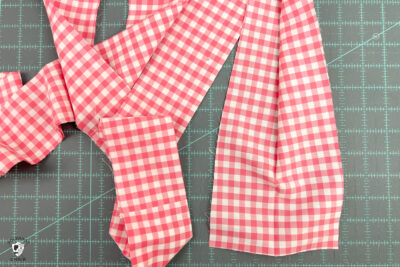 pink gingham fabric folded in half