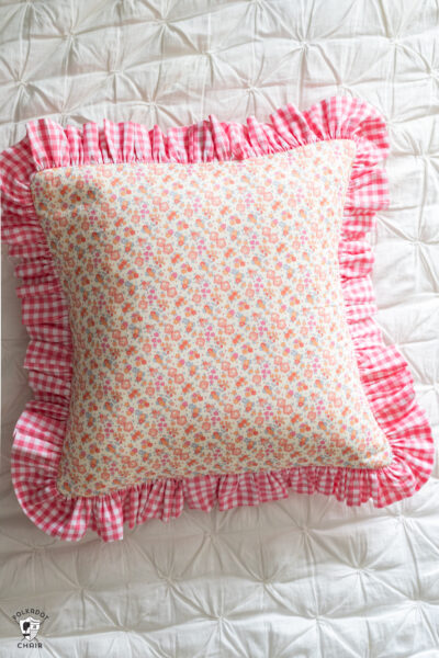 pink floral pillow on white duvet cover