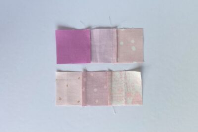 squares of pink fabric sewn together on white tabletop