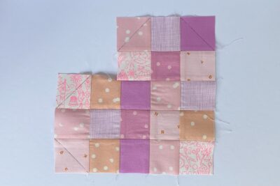 squares of pink fabric sewn together on white tabletop