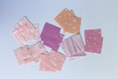 squares of pink fabric sewn together on white tabletop