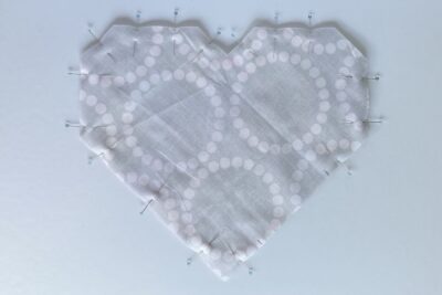 gray fabric heart on table