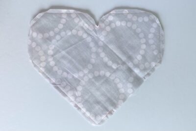 gray fabric heart on table