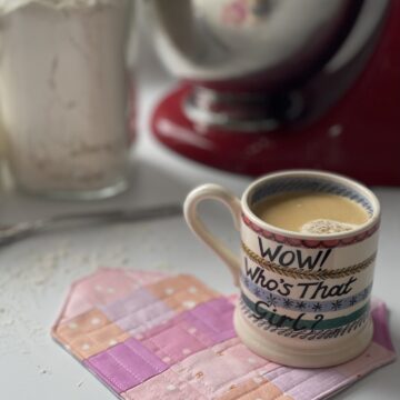pink heart mug rug on table with coffee cup