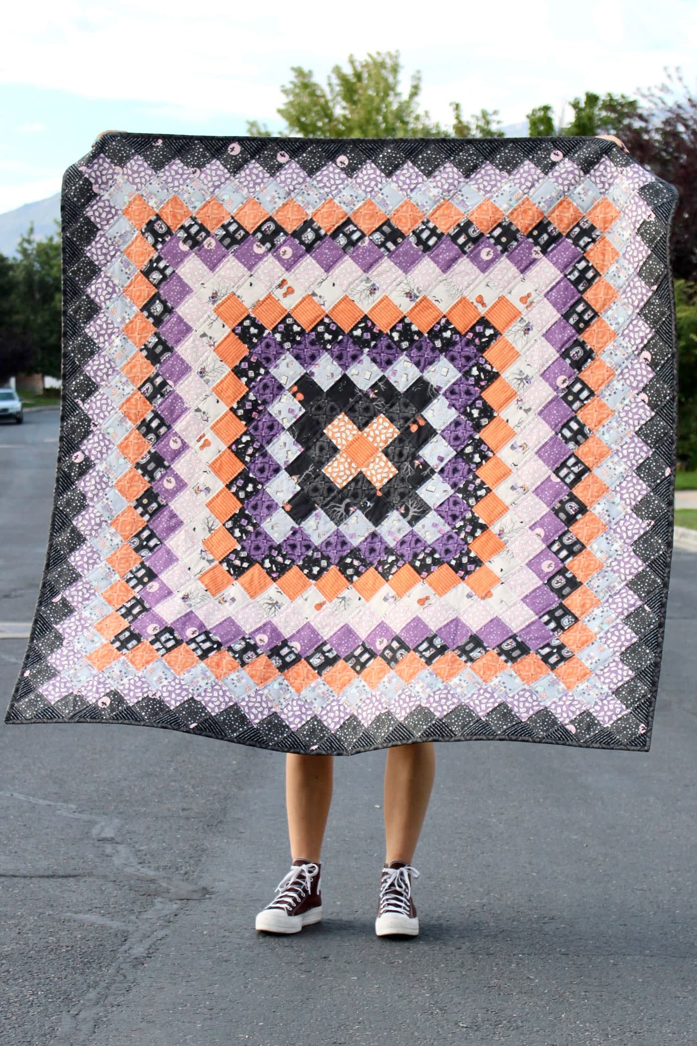 black, orange and purple patchwork quilt outdoors