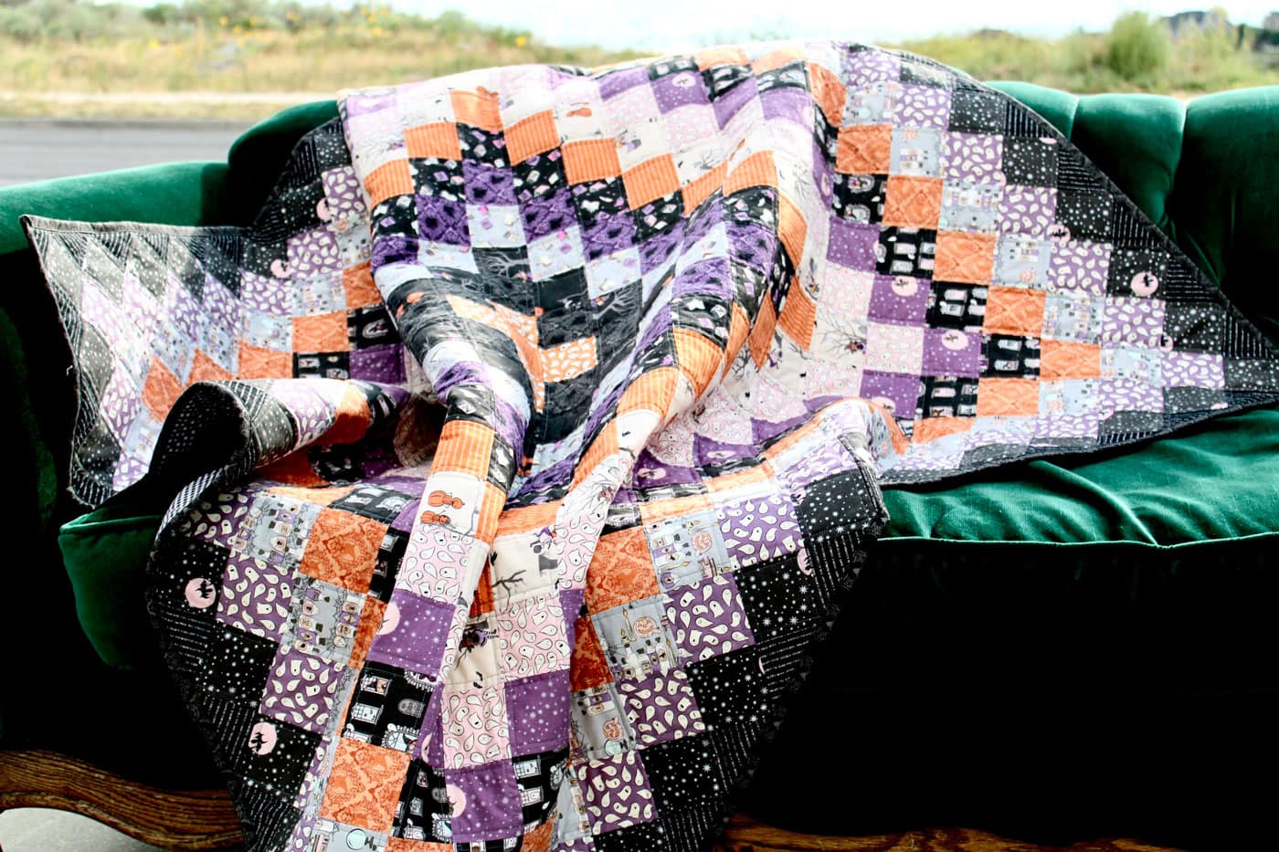 black, orange and purple patchwork quilt outdoors