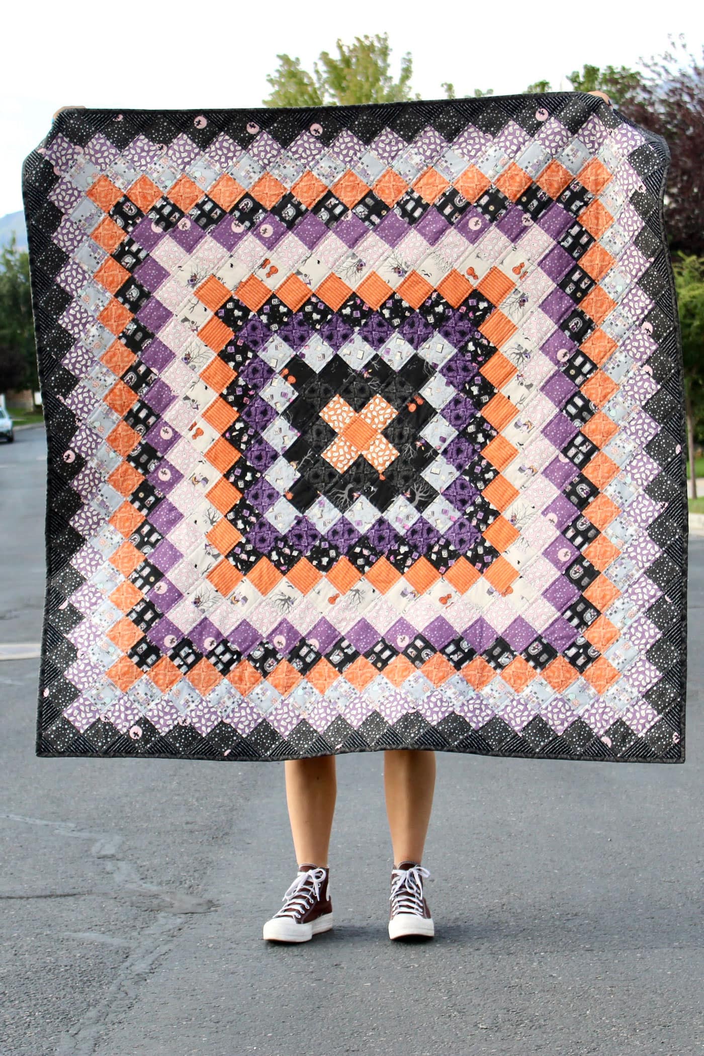 black, orange and purple patchwork quilt outdoors