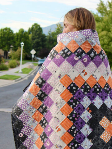 black, orange and purple patchwork quilt outdoors