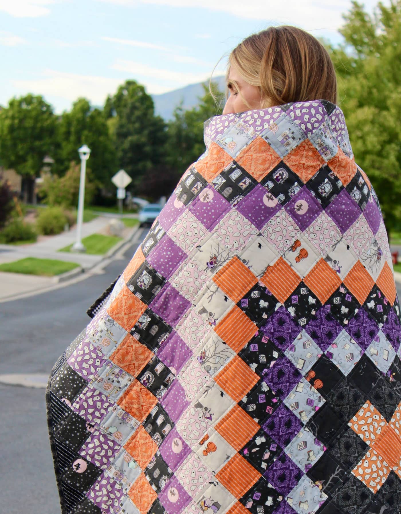 black, orange and purple patchwork quilt outdoors