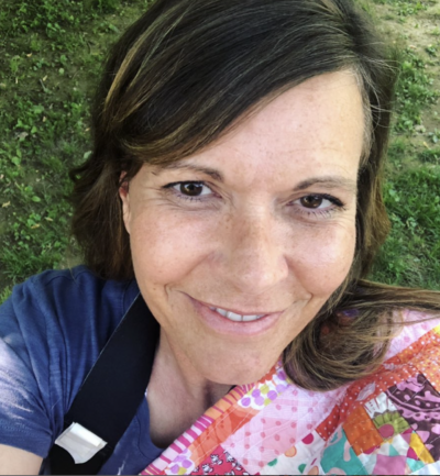 woman holding quilt