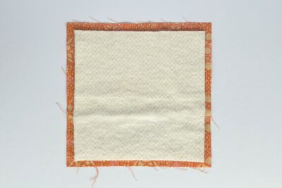 batting and orange square of fabric